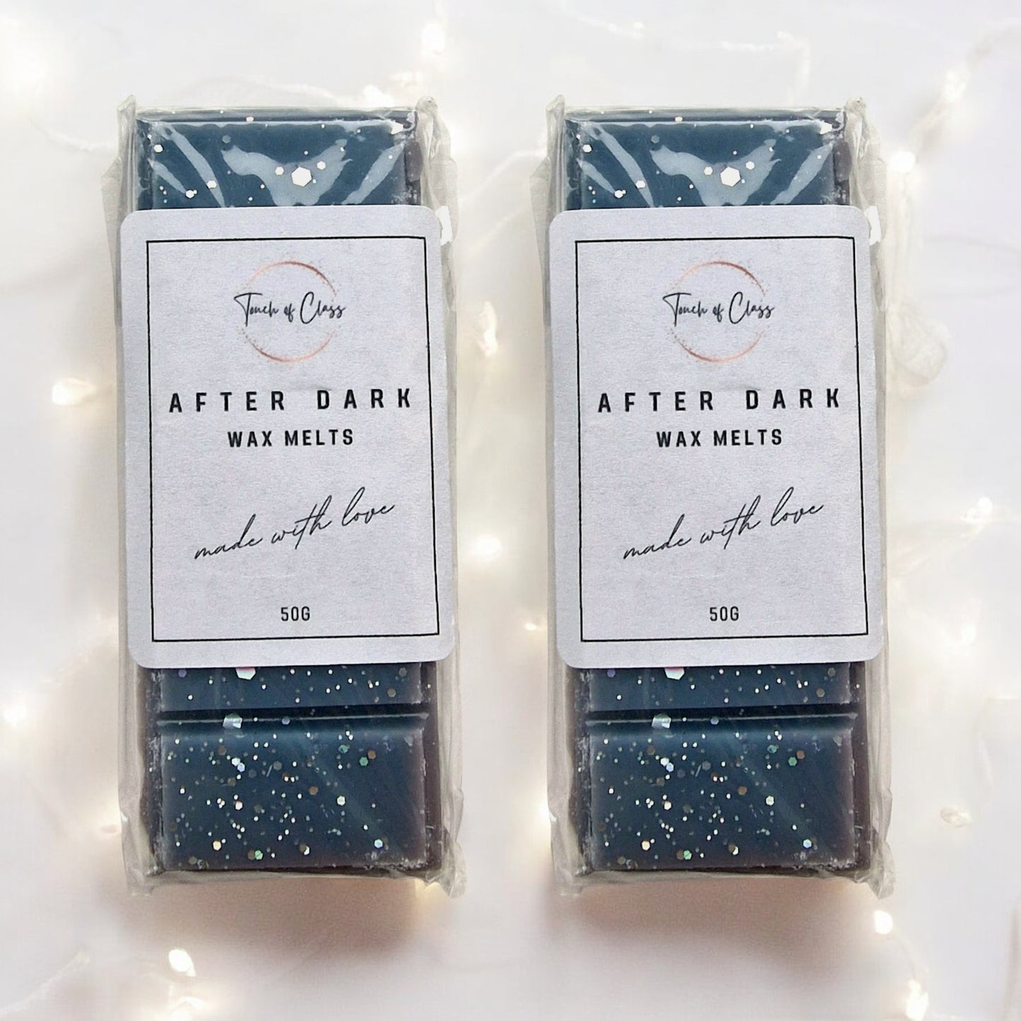 A close up photo of After Dark wax melts by touch of class. The wax melt is in the shape of a snap bar