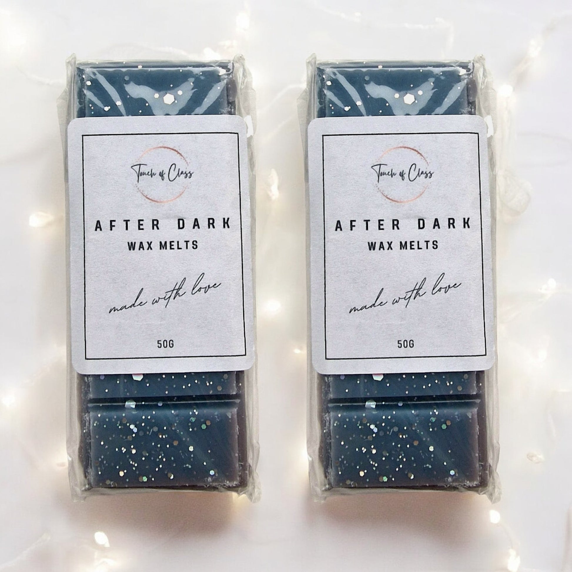 A close up photo of After Dark wax melts by touch of class.  The wax melt is in the shape of a snap bar
