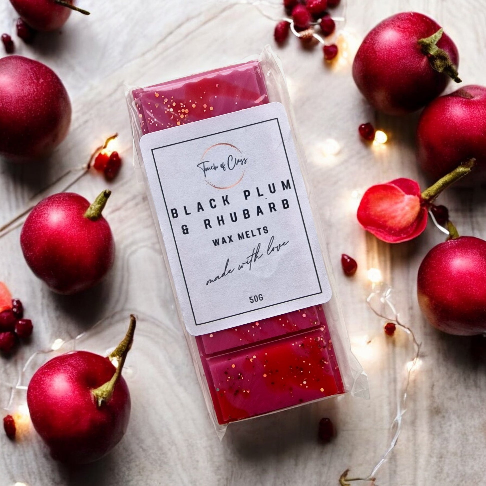 A close up of Black Plum & Rhubarb wax melts by Touch of Class.  The wax melt is in the shape of a snap bar