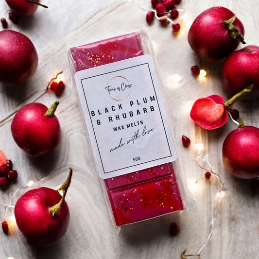 A close up of Black Plum & Rhubarb wax melts by Touch of Class.  The wax melt is in the shape of a snap bar