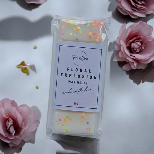 a close up of Floral Explosion Wax melt by Touch of class.  The wax melt is in the shape of a snap bar